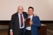 Dr. Nagib Callaos, General Chair, giving Prof. Anastassis Kozanitis a plaque "In Appreciation for Delivering a Great Keynote Address at a Plenary Session."